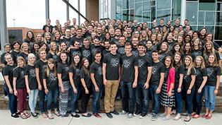 A group of Discipleship leaders stands on the BTS steps